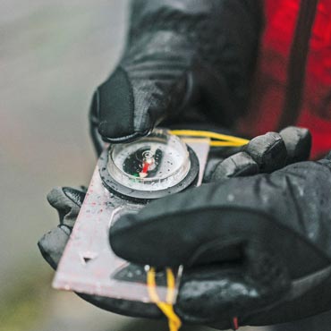 Hands holding a compass