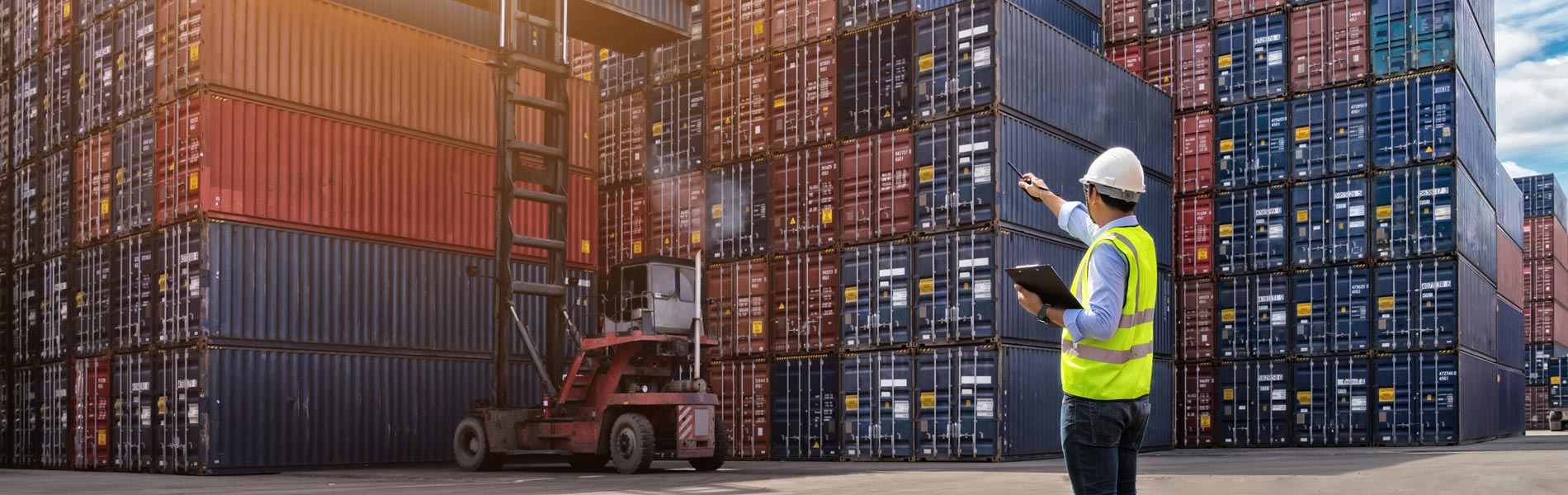 Man directing the loading of cargo at a port