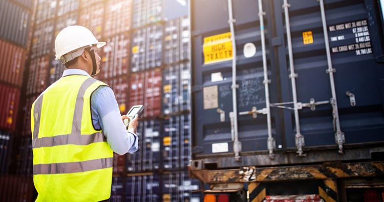 Foreman loading containers at a cargo port