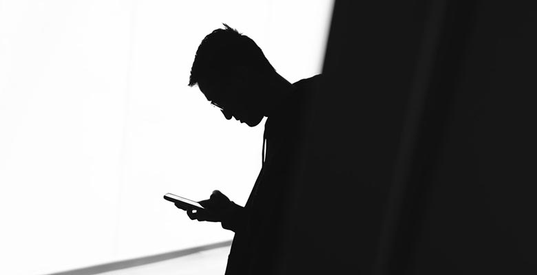 Silhouette of a man using a mobile phone