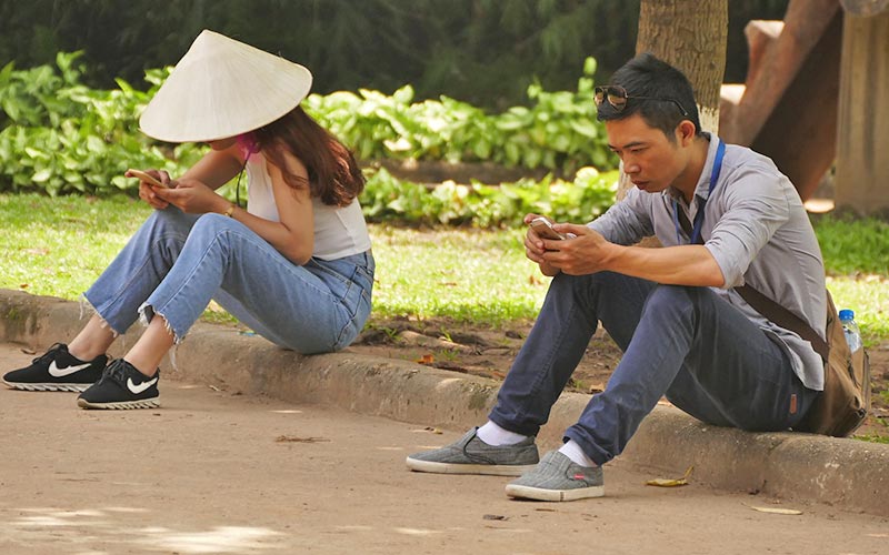 People using smartphones in Vietnam