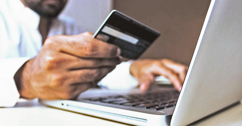 Man using a credit card to shop online