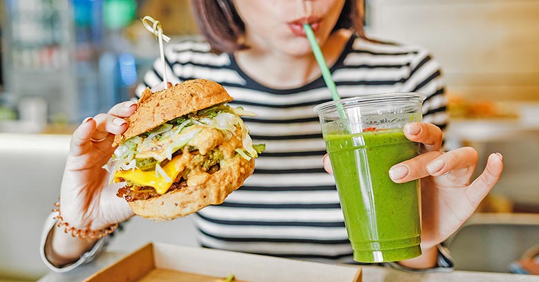 Woman eating a vegan burger