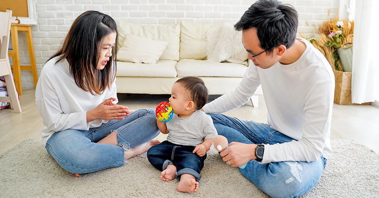 Chinese parents playing with a baby