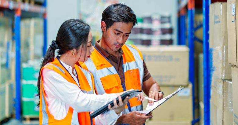 Supplier checking paperwork in a warehouse