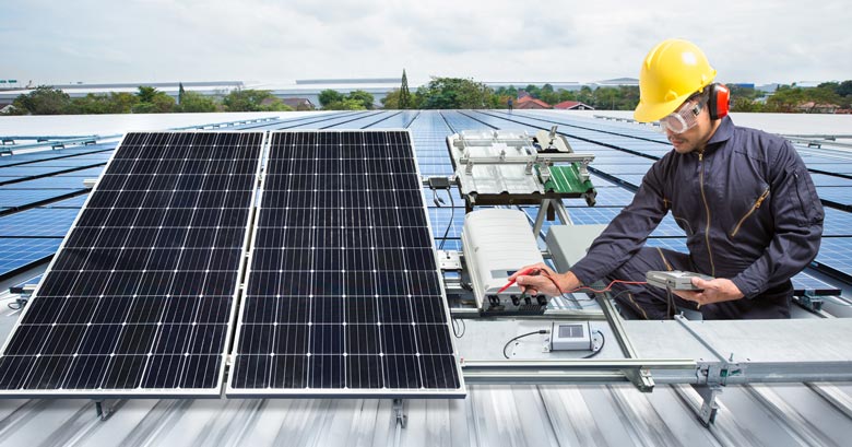 Engineer installing solar panels on a warehouse roof in Thailand