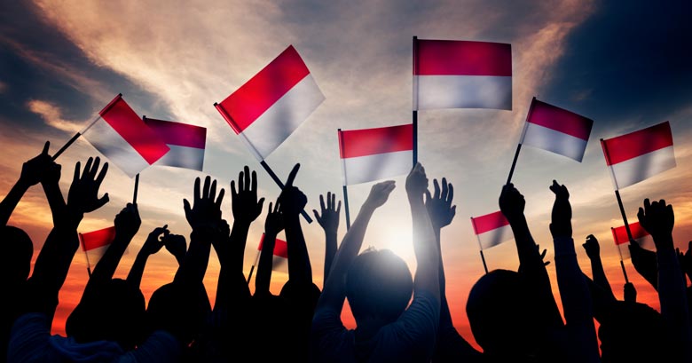 People waving Indonesian flags