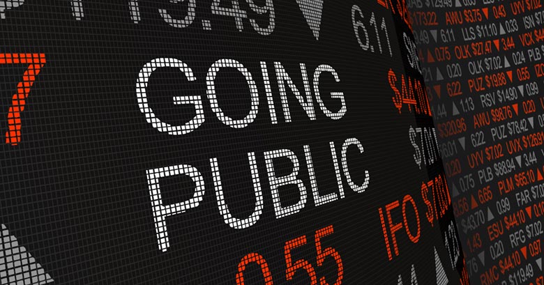 Stock market display board including the words 'Going Public'